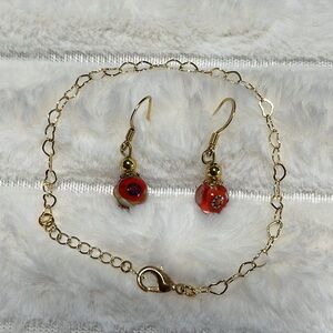 Beautiful gold tone heart design bracelet and  French wire earring set.